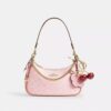 Bolsos de hombro Teri en Signature Canvas con Charms
