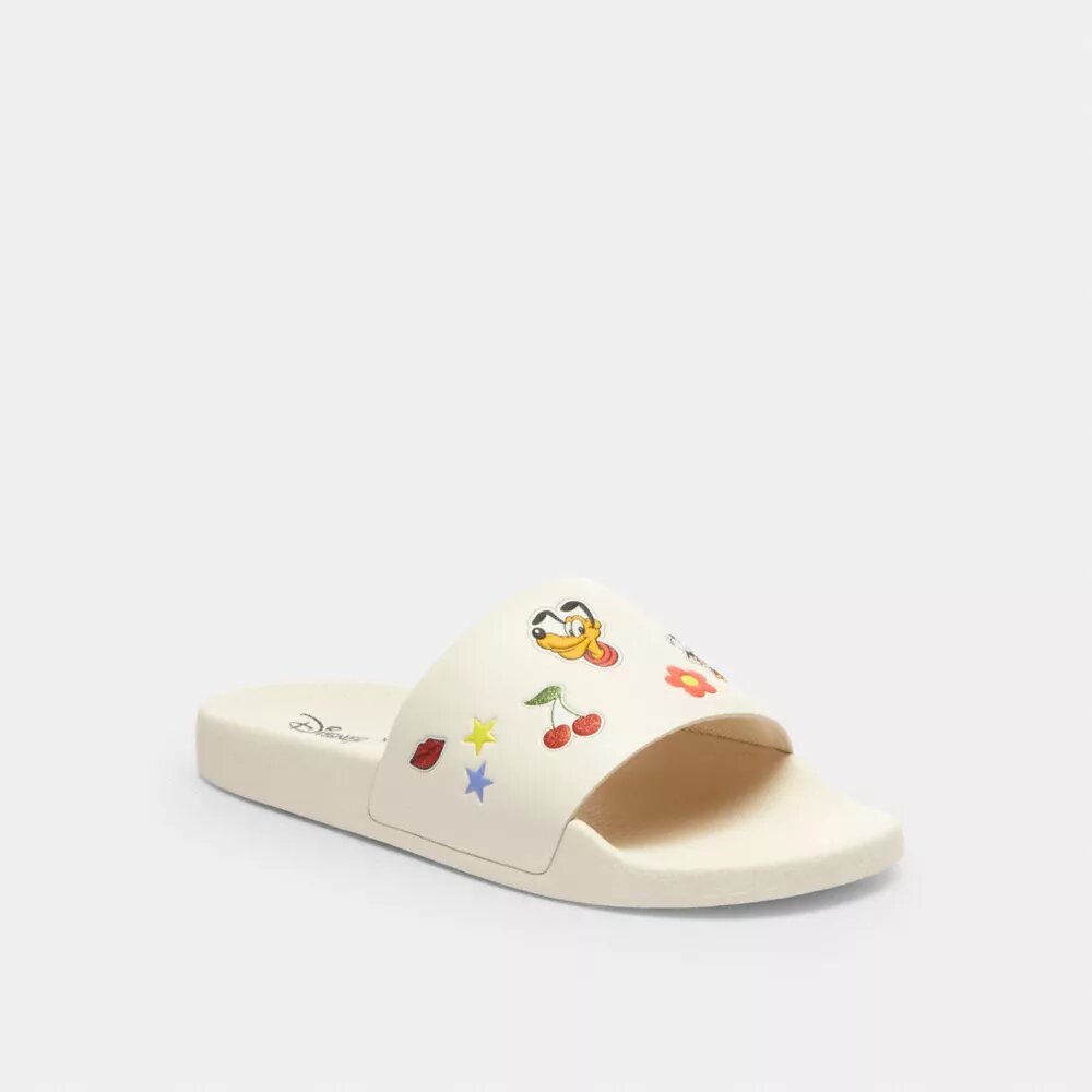 Chanclas deportivas Udele de Disney X Coach con estampado de calcomanías