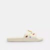 Chanclas deportivas Udele de Disney X Coach con estampado de calcomanías