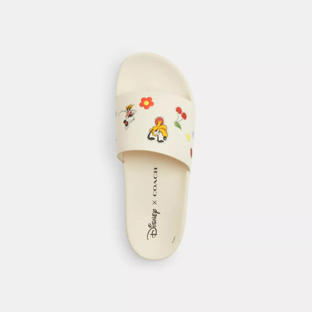 Chanclas deportivas Udele de Disney X Coach con estampado de calcomanías